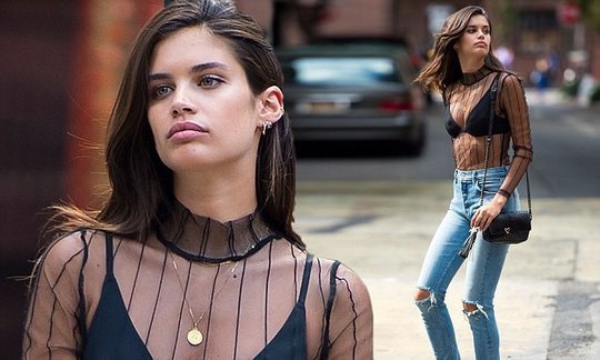 Sara Sampaio models sheer top and ripped jeans on NYC street
